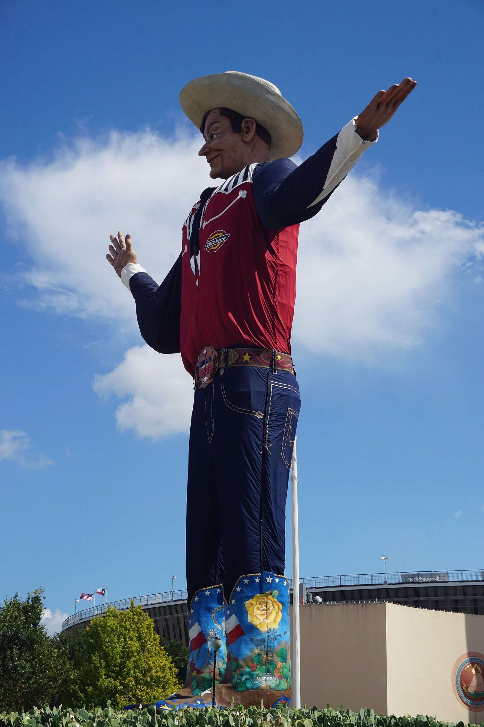 Big Tex, the giant cowboy statue that greets visitors in this State Fair of Texas first timer guide, against a blue sky