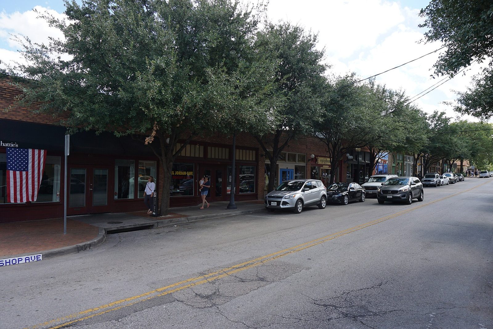 Low brick storefronts and boutiques in the Bishop Arts District of Oak Cliff