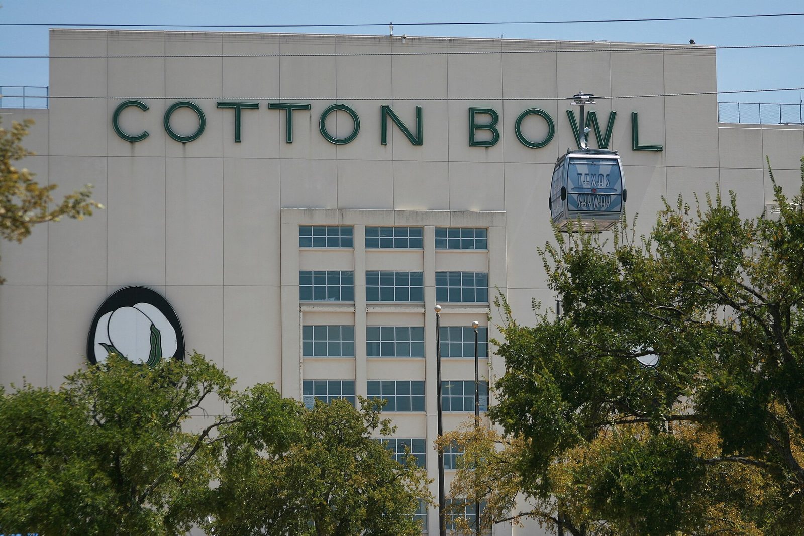 The Cotton Bowl stadium at Fair Park in Dallas with a cable car gondola passing overhead