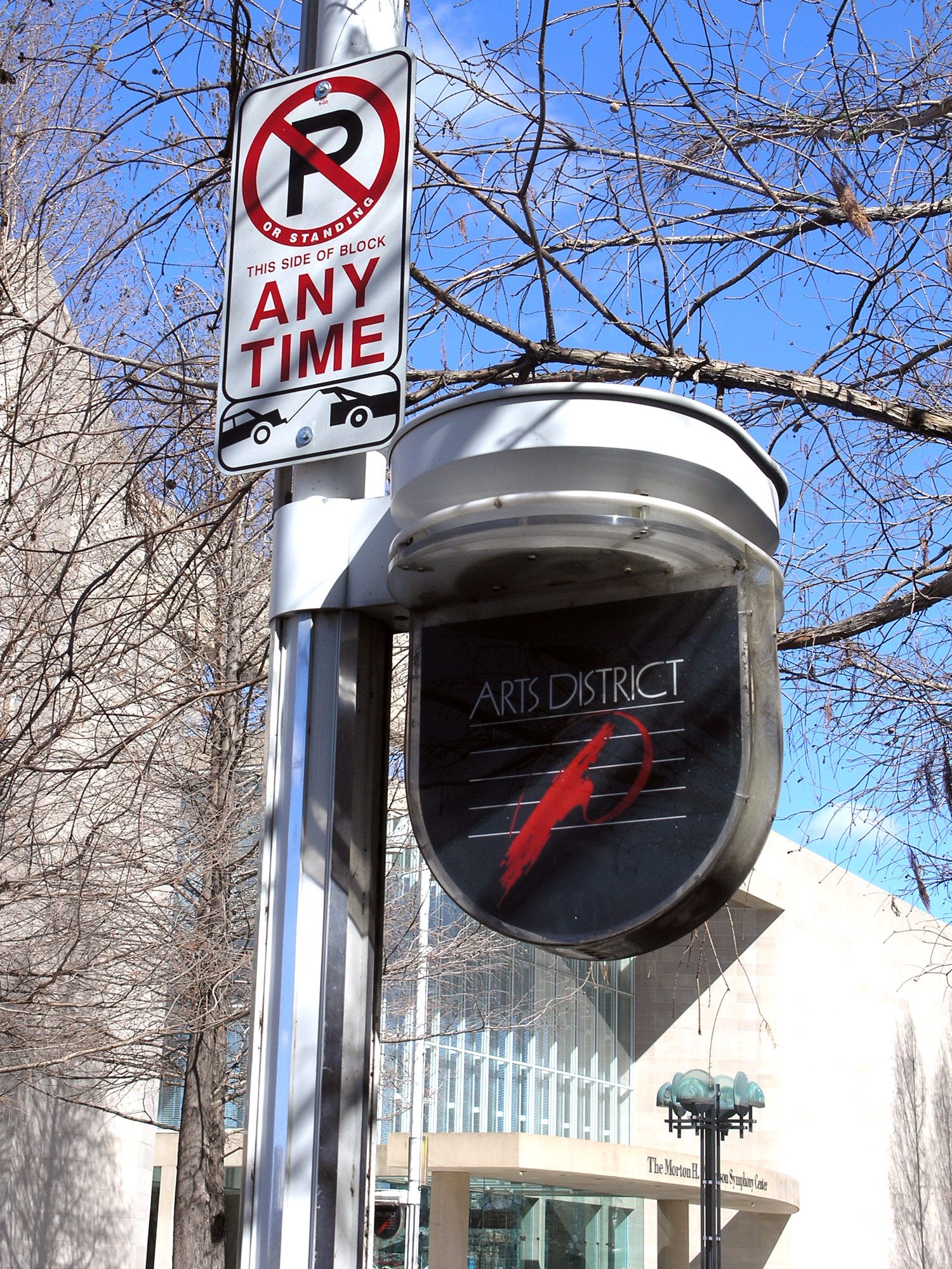 A Dallas Arts District street sign mounted on a pole against a winter sky