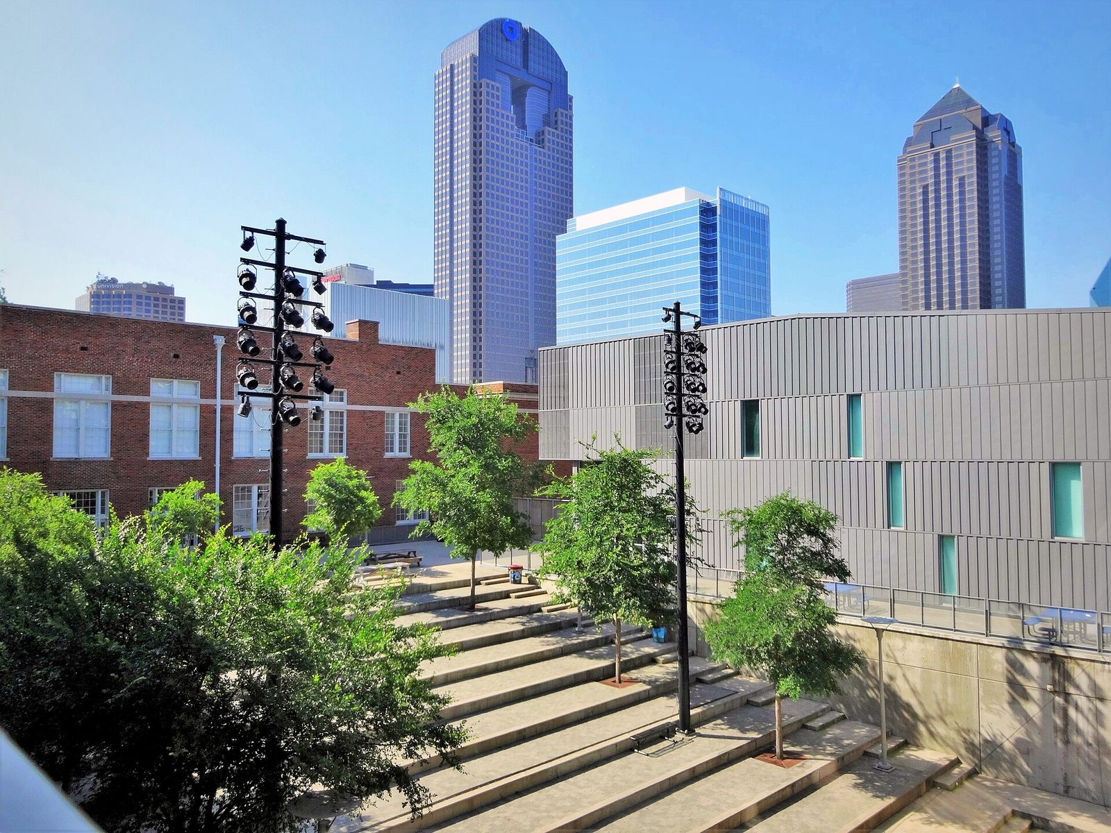 A street in the Dallas Arts District with the downtown skyline rising behind