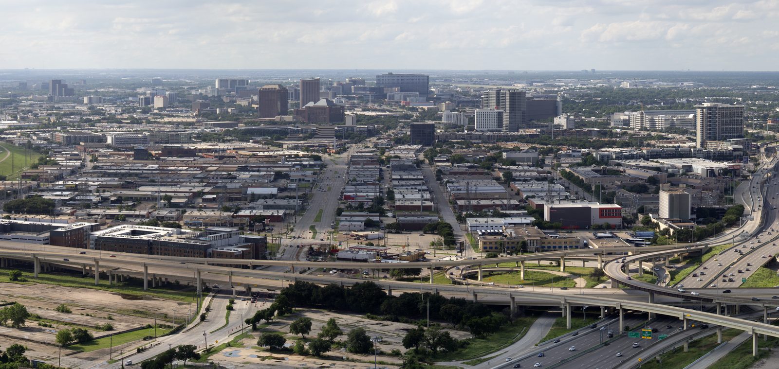 An aerial view over the Dallas Design District showing freeways and low warehouse blocks