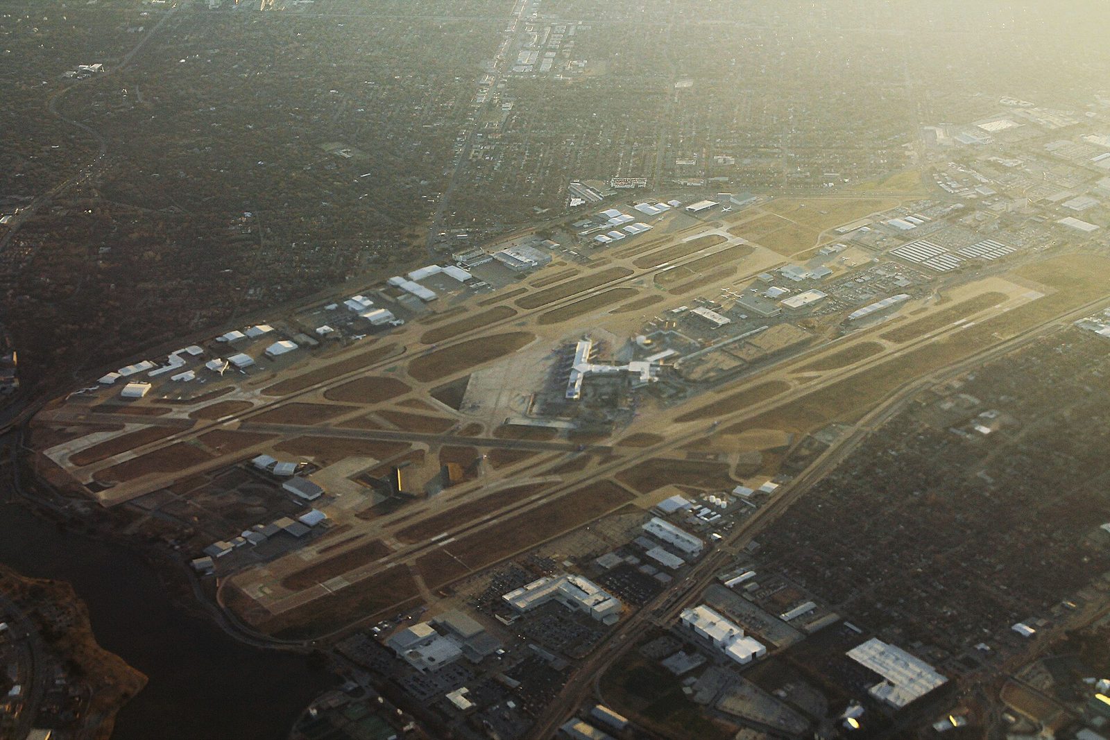 Aerial view of Dallas Love Field with its single runway complex surrounded by city streets