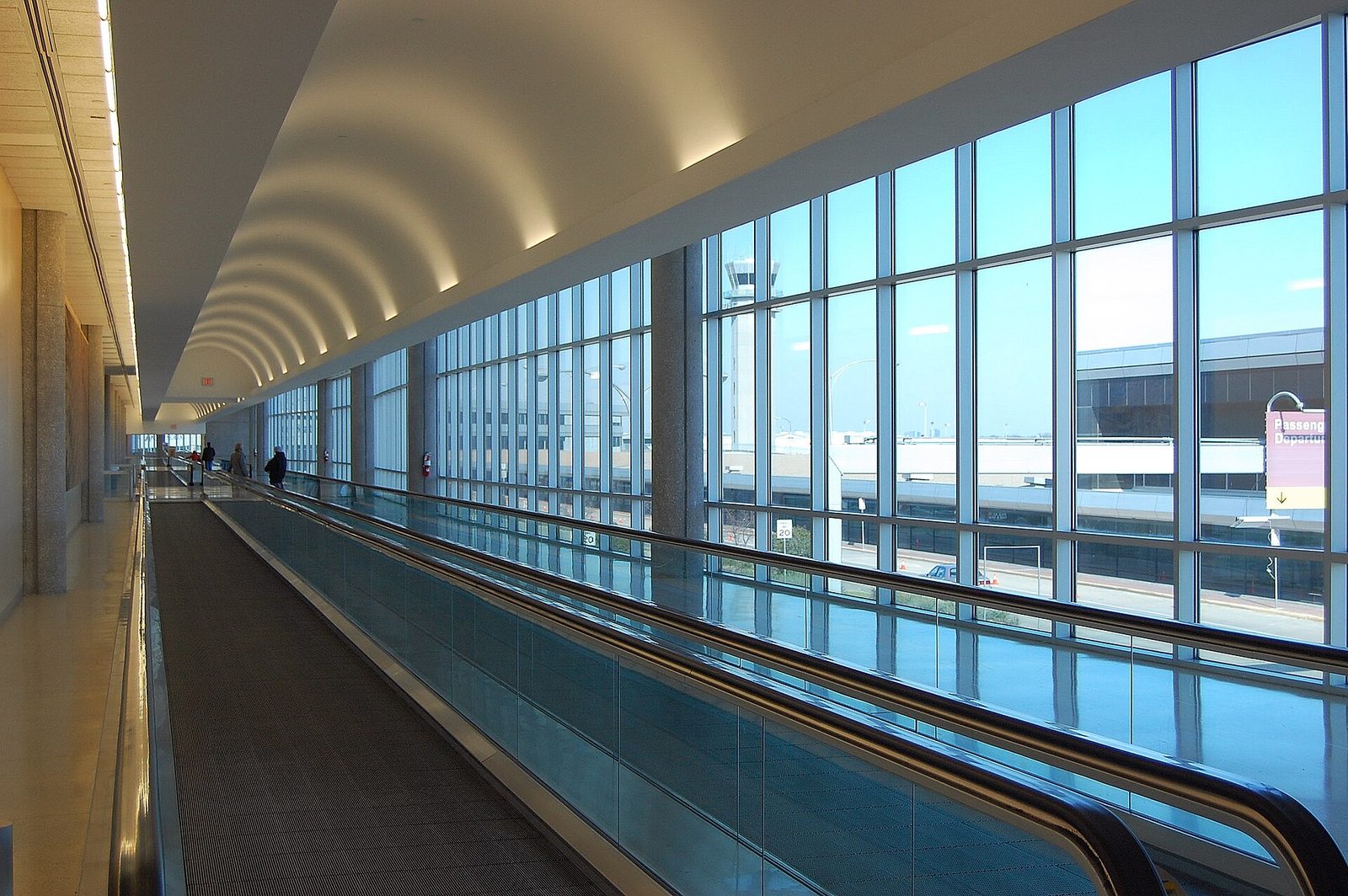 Long glass-walled skybridge with a moving walkway at Dallas Love Field airport