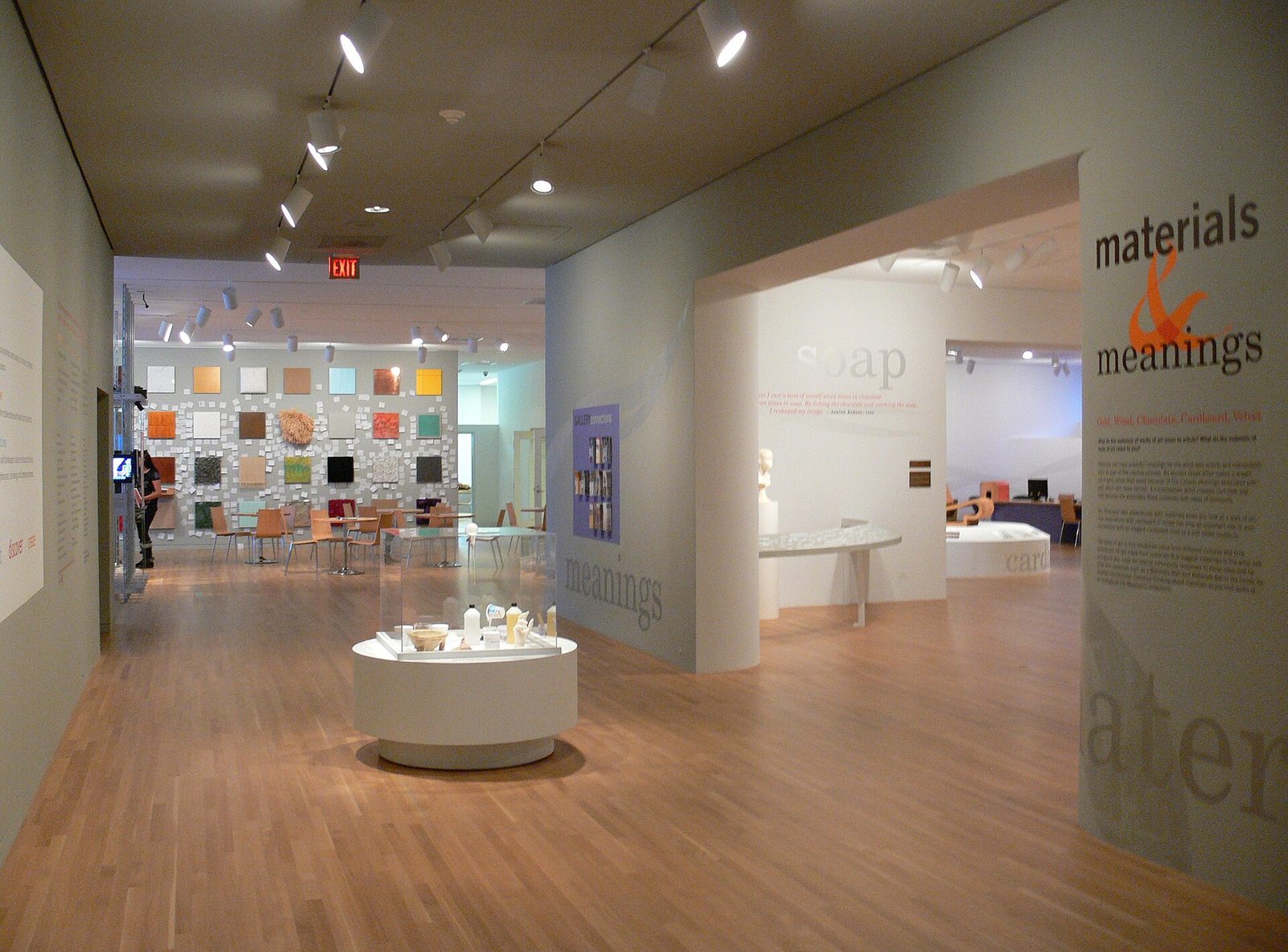 Wide wooden-floored gallery with open circulation space inside the Dallas Museum of Art