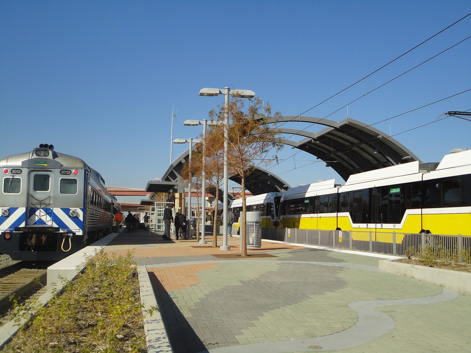 A DART light rail train at a Green Line station platform in Dallas