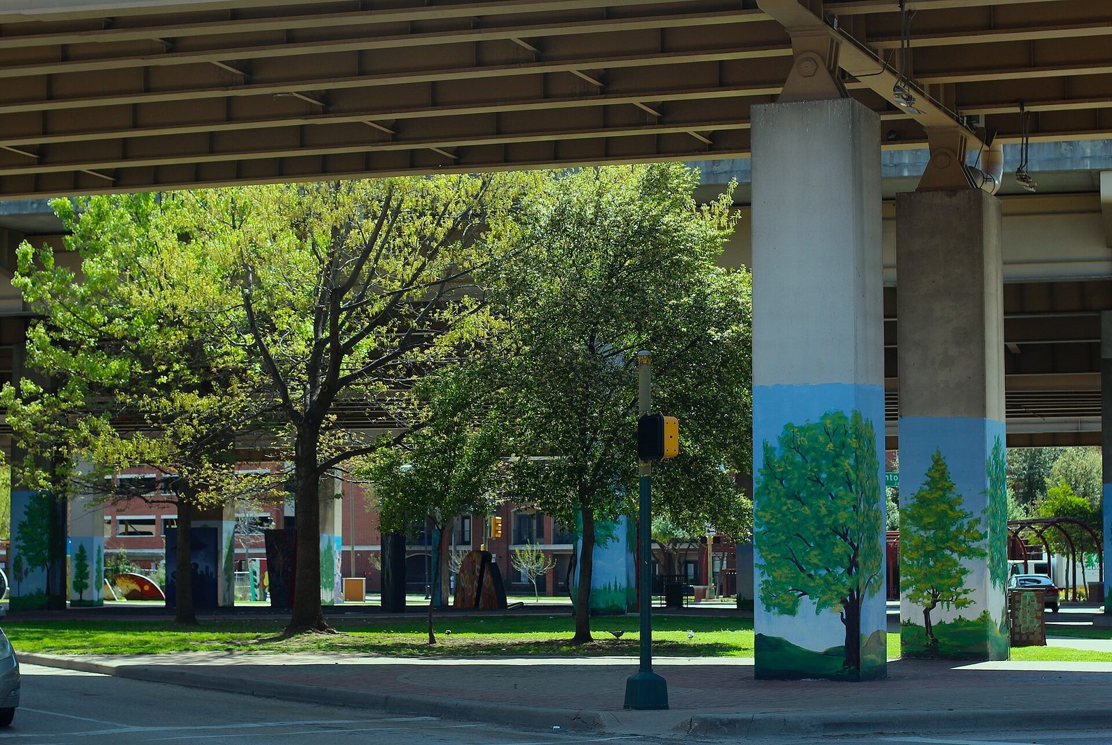 Painted columns beneath an elevated roadway at the edge of Deep Ellum in Dallas