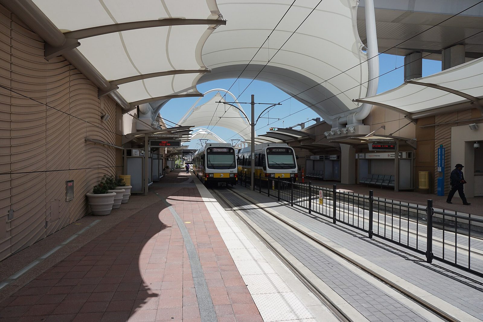 DART trains waiting at the covered airport rail station at DFW