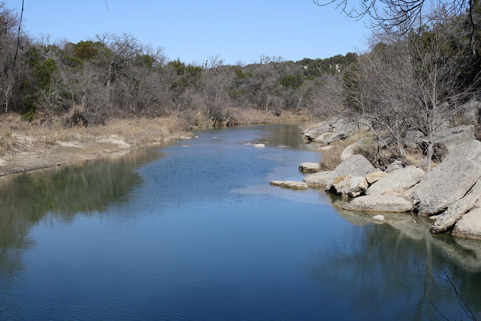 The shallow Paluxy River running over pale limestone shelves at Dinosaur Valley State Park