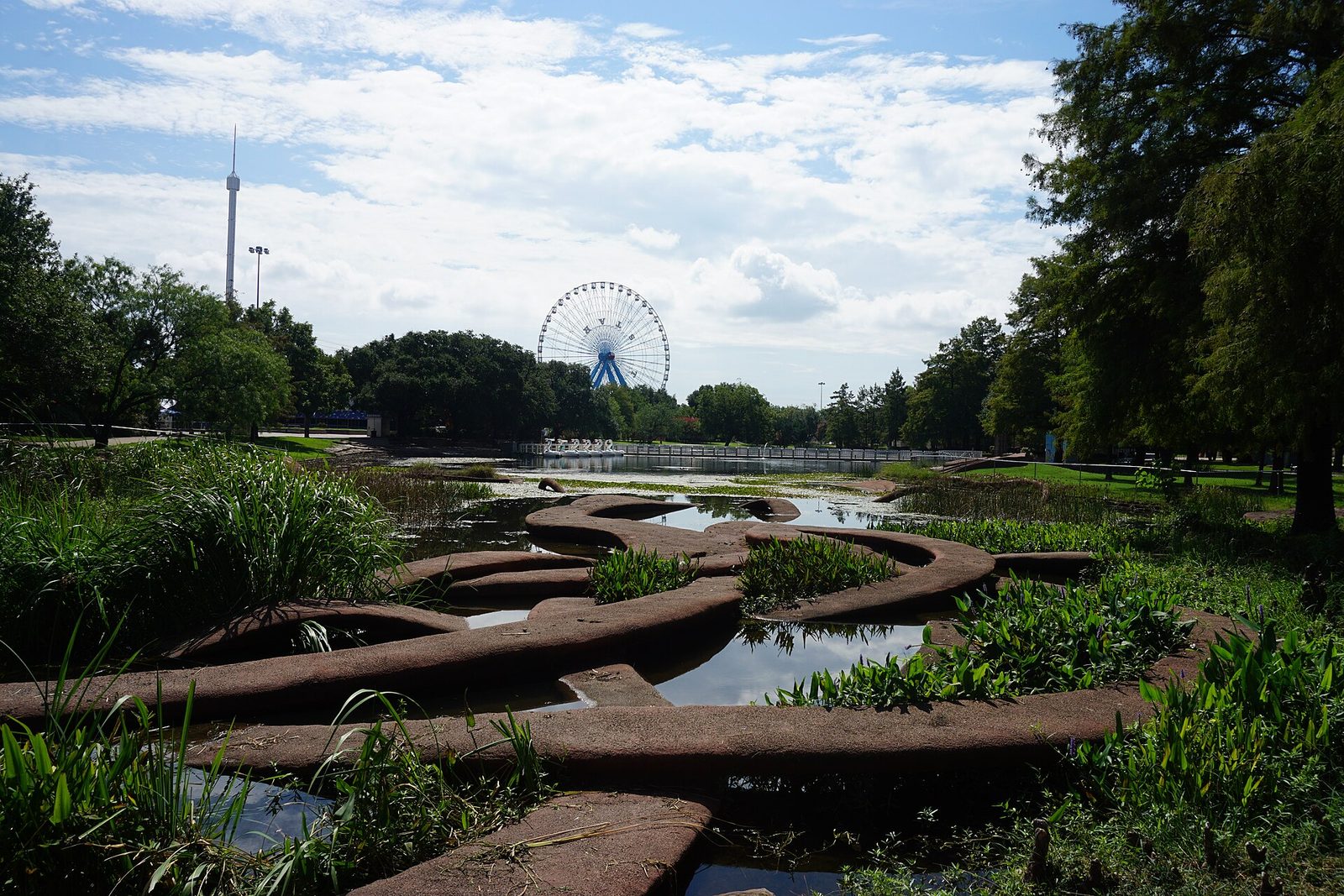 The Leonhardt Lagoon at Fair Park with sculpted landforms and trees