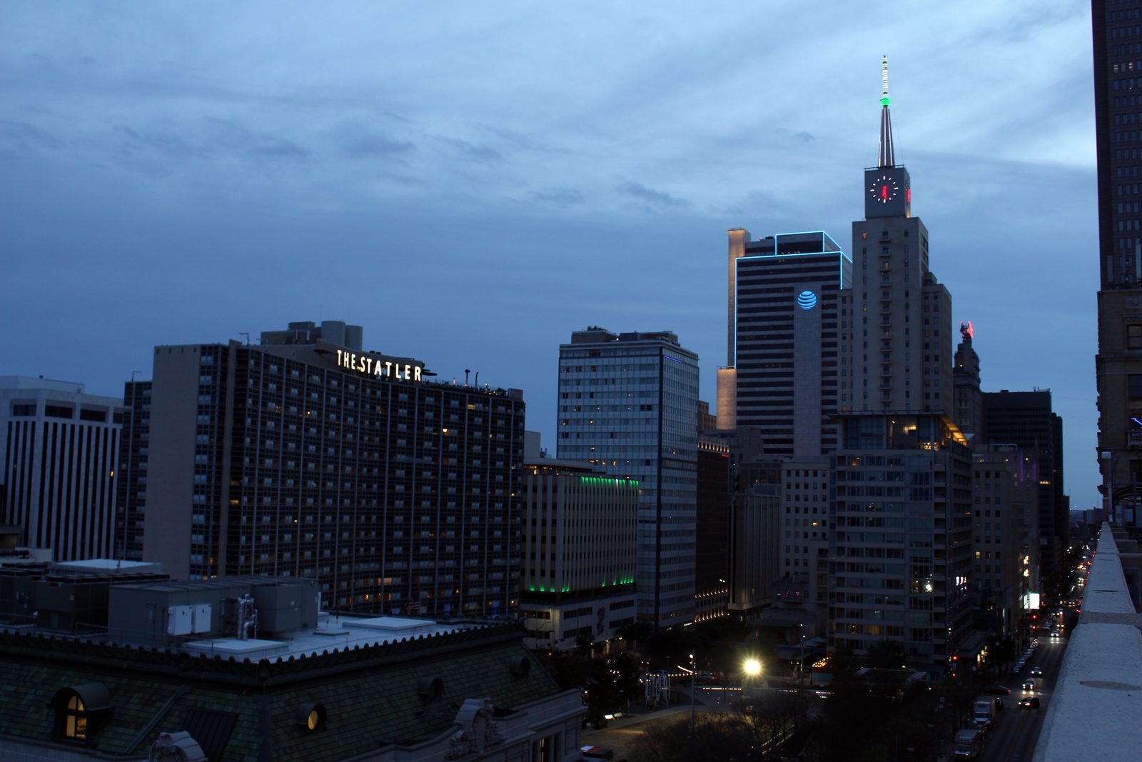 Main Street Garden park in downtown Dallas at dusk with lit towers behind