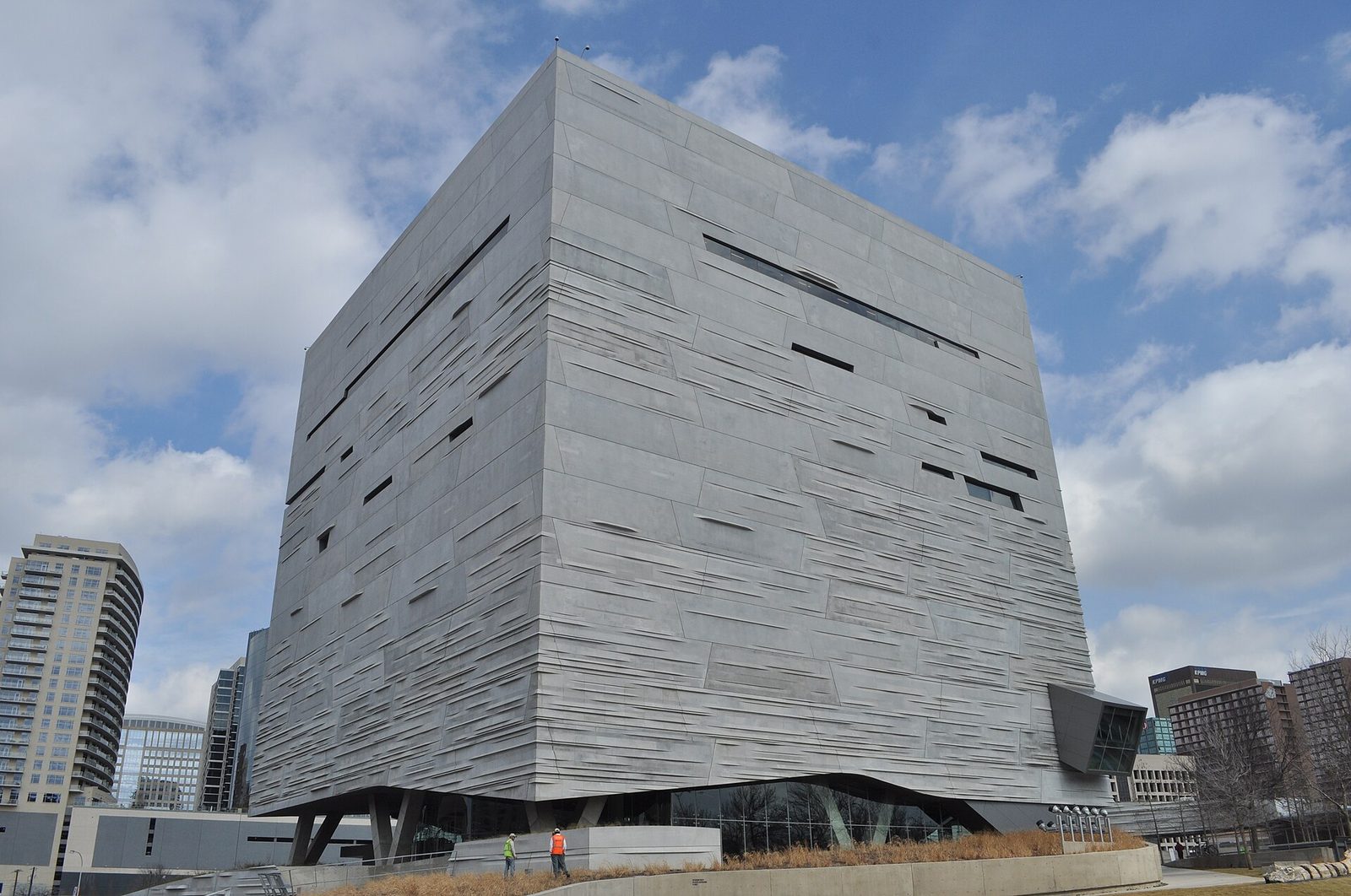 The angular limestone cube of the Perot Museum of Nature and Science against a blue sky