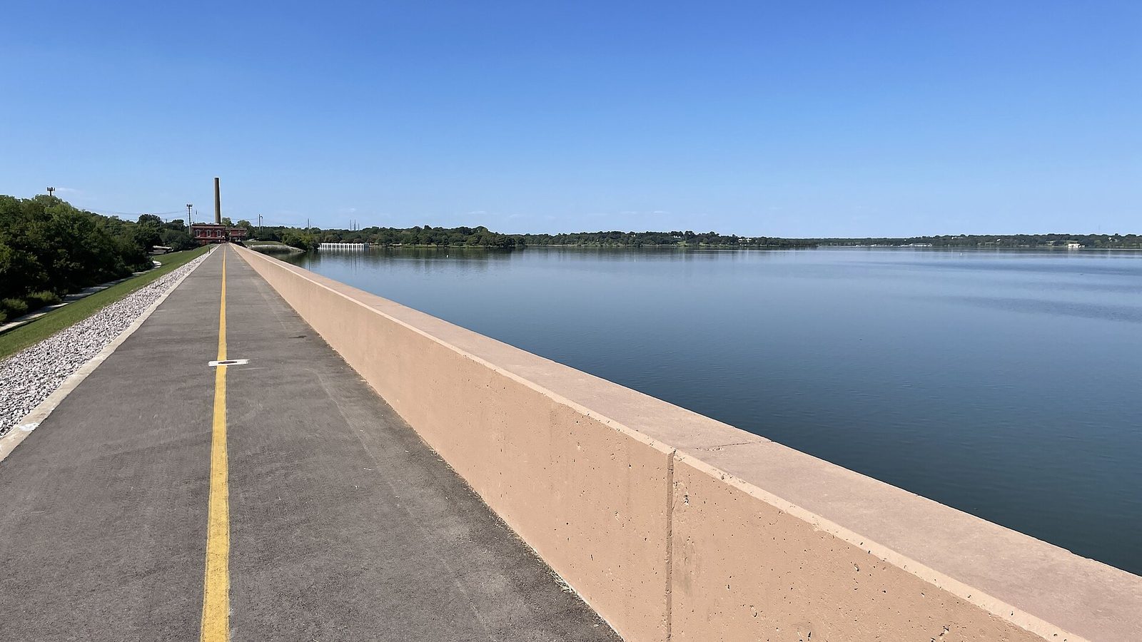 Open water and the shoreline path at White Rock Lake in Dallas under a clear sky
